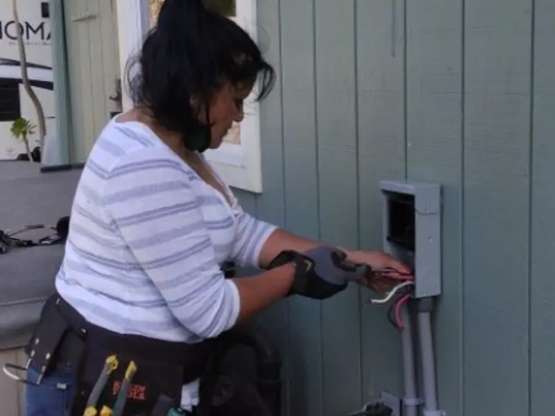 Licensed electrician wiring an exterior subpanel in Mills
